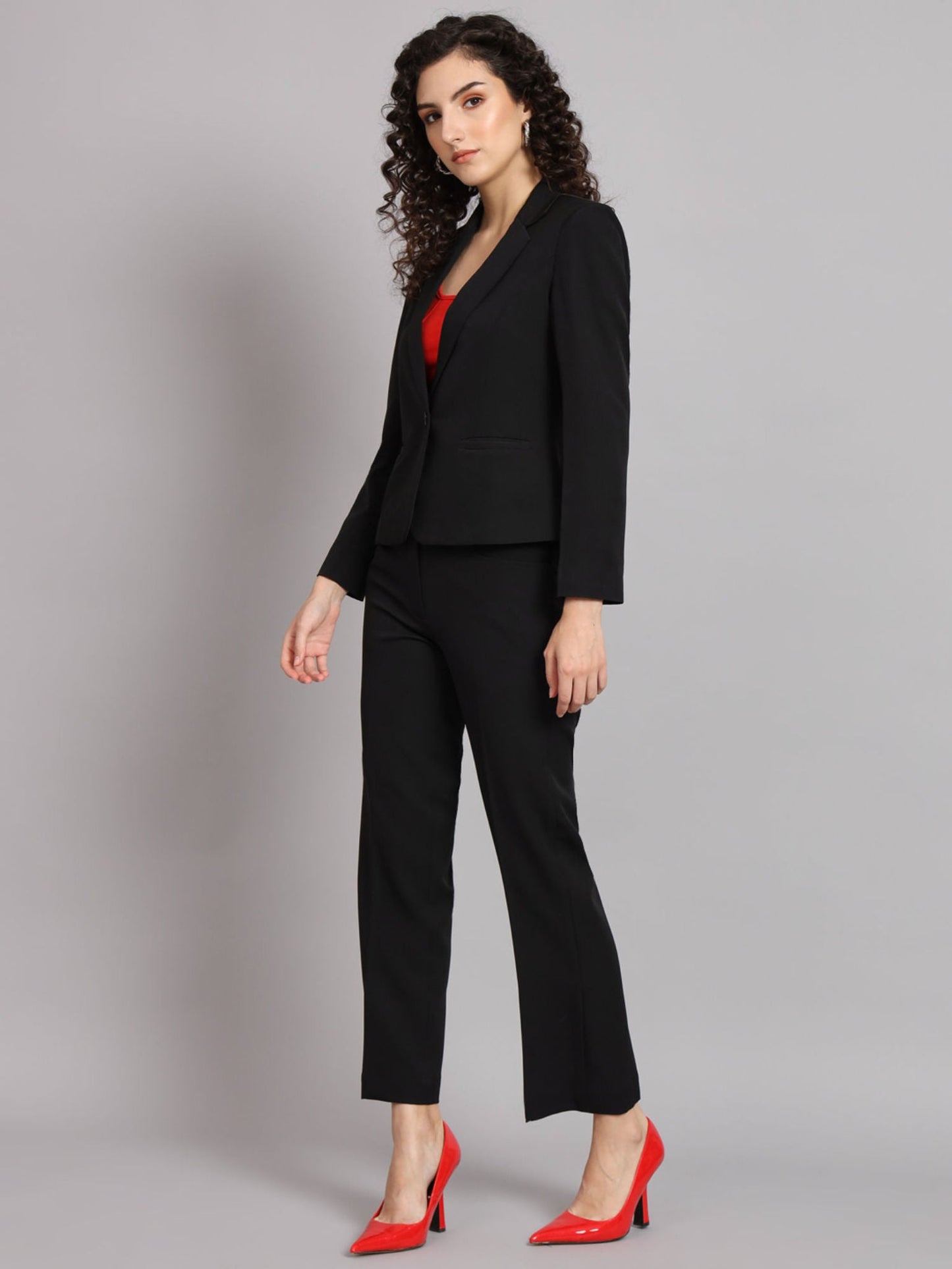 XAYWEAR black blazer for women paired with matching pants and red shoes in professional suit look