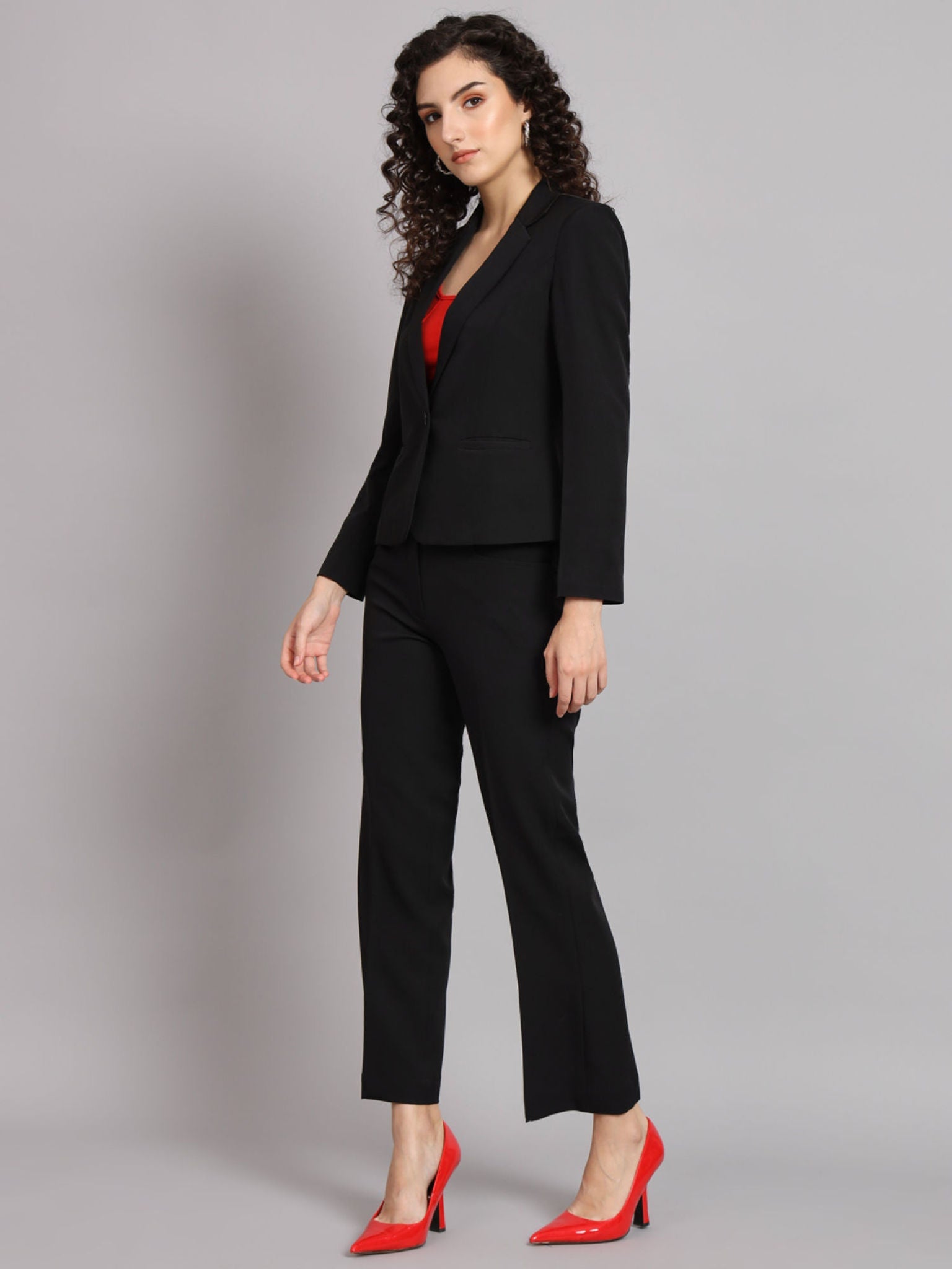 XAYWEAR black blazer for women paired with matching pants and red shoes in professional suit look