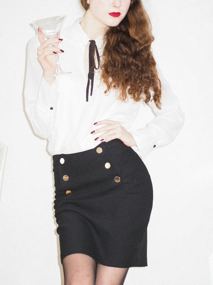 XAYWEAR black skirt mini length with decorative buttons, styled with white blouse for a chic look