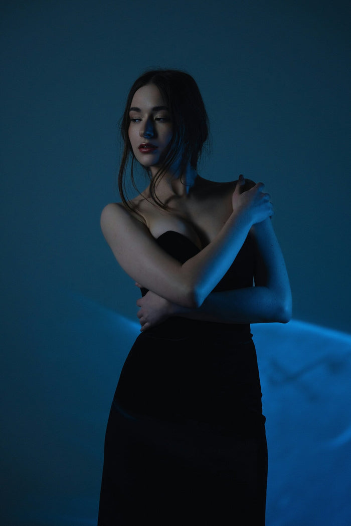 Elegant model wearing a premium black gown with a sleek design and luxurious fabric