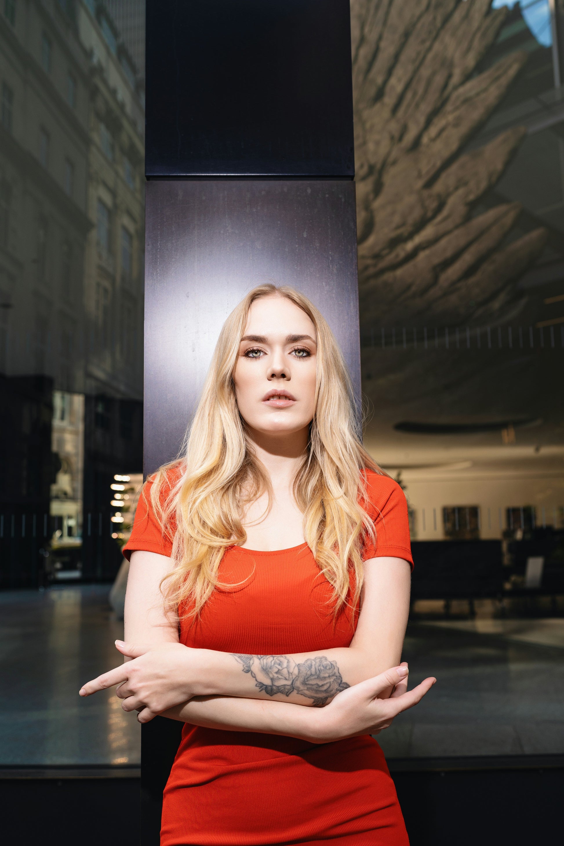 Stylish woman in a Premium Red Bodycon Dress posing confidently outdoors