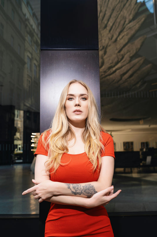 Stylish woman in a Premium Red Bodycon Dress posing confidently outdoors