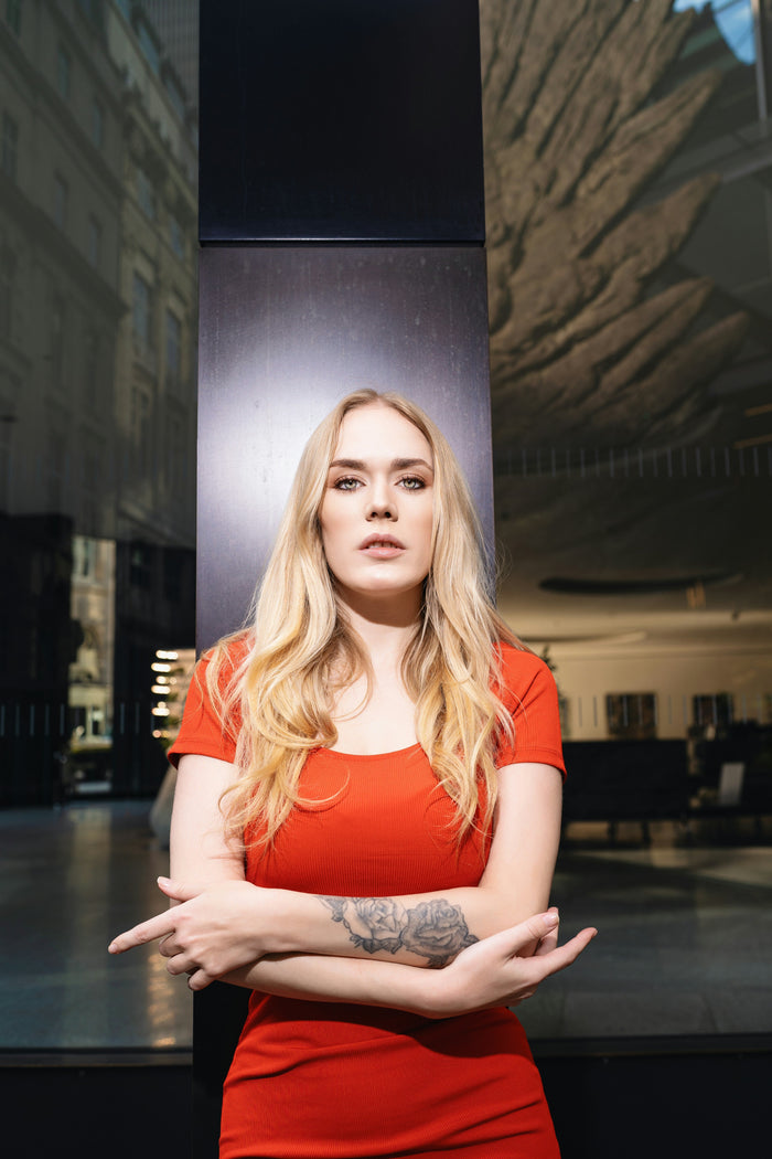Stylish woman in a Premium Red Bodycon Dress posing confidently outdoors