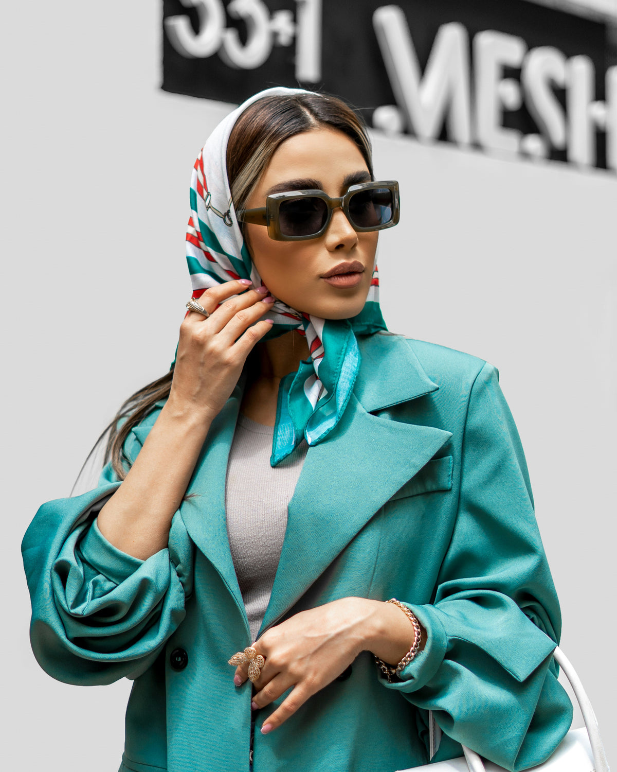 Teal double-breasted blazer by XAYWEAR paired with a stylish scarf and sunglasses for a chic look
