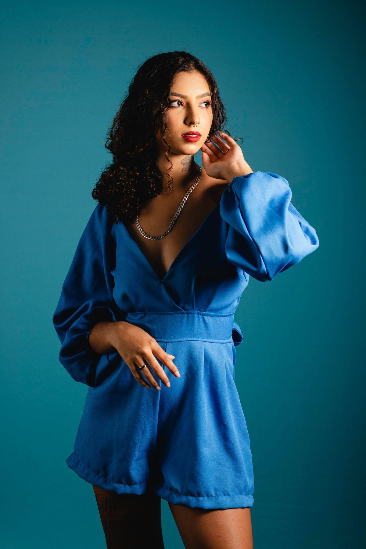 XAYWEAR women blue jumpsuit with long puff sleeves and deep V neckline on model