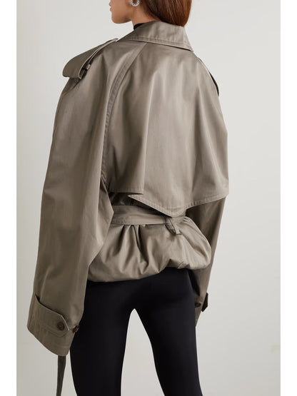 XAYWEAR women trench coat in taupe color shown from the back with belted waist and storm flap detail